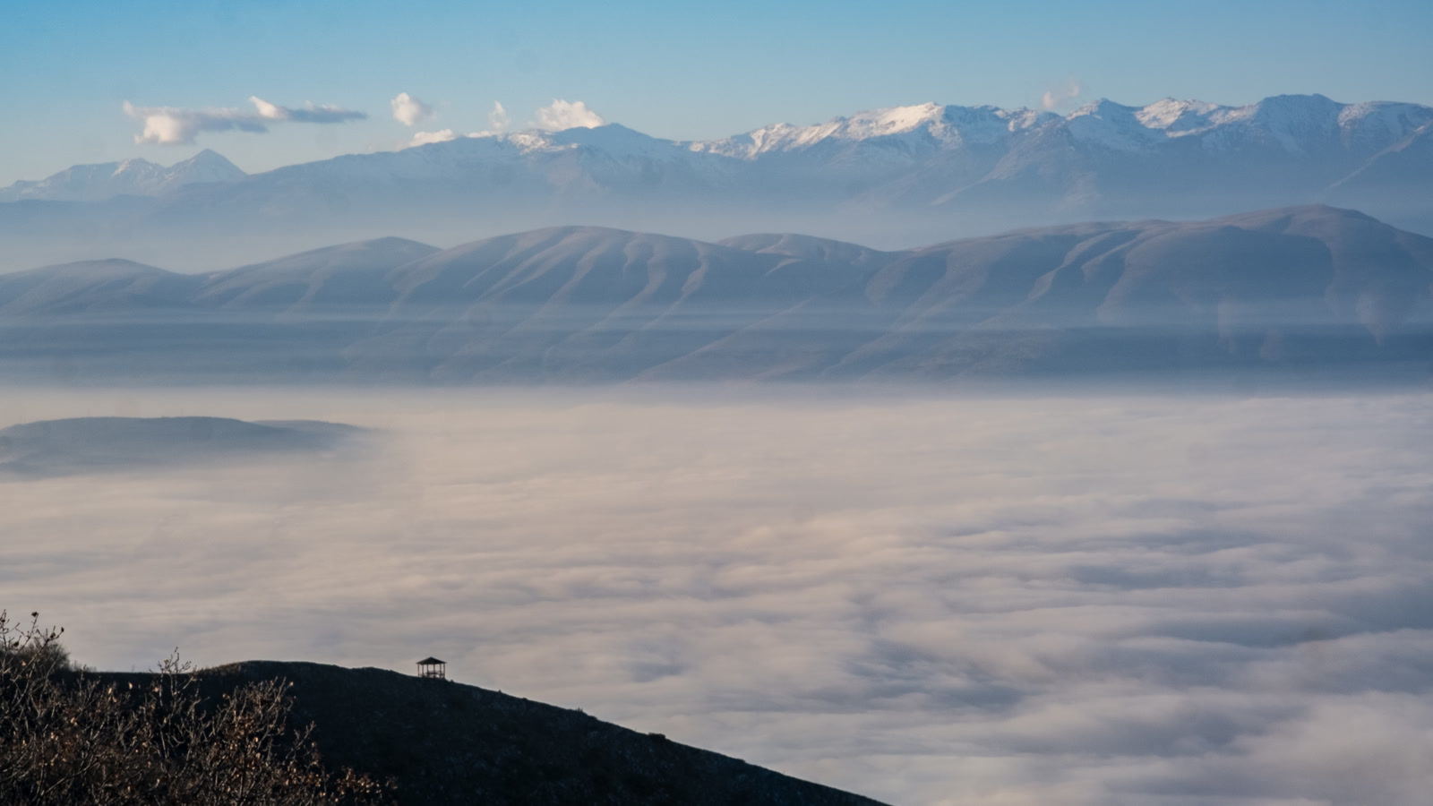 Mountain range standing above a sea of cloud