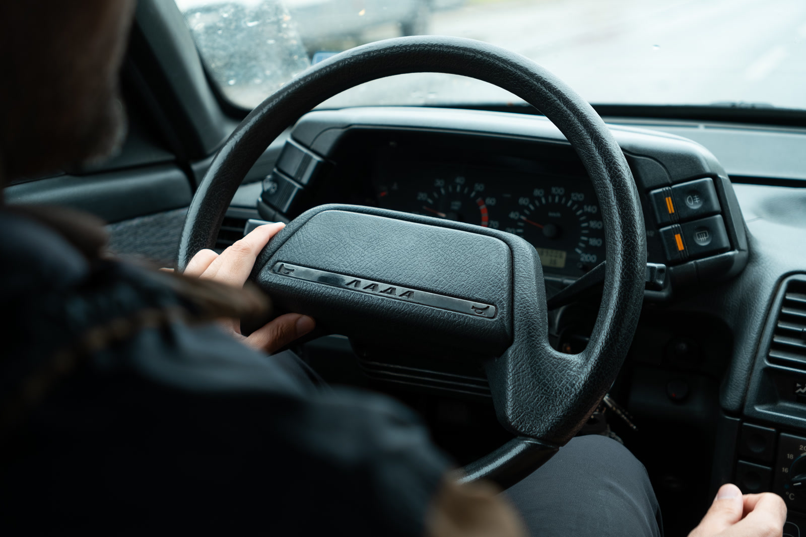 Hands on the wheel of an old Lada