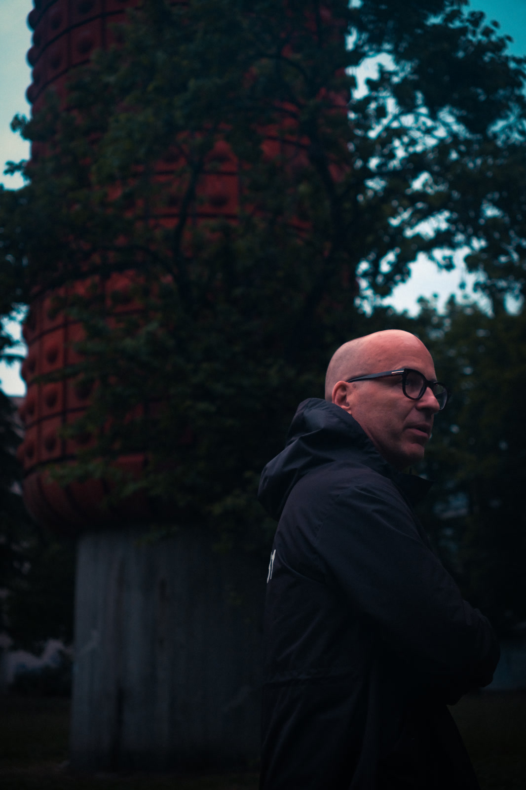 Portrait against a painted column and trees