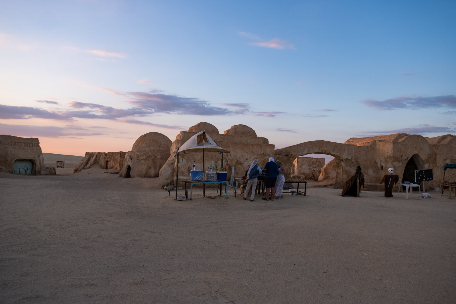 Traders in a mud-brick courtyard at dusk