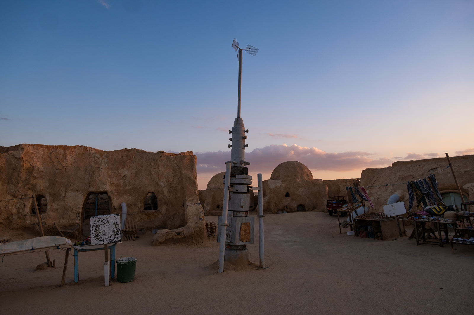 Street lamp among mud-brick domes at sunset