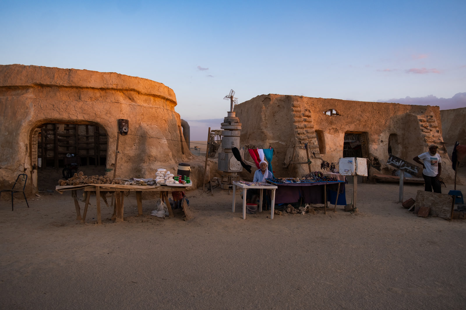 Market tables in a mud-brick courtyard